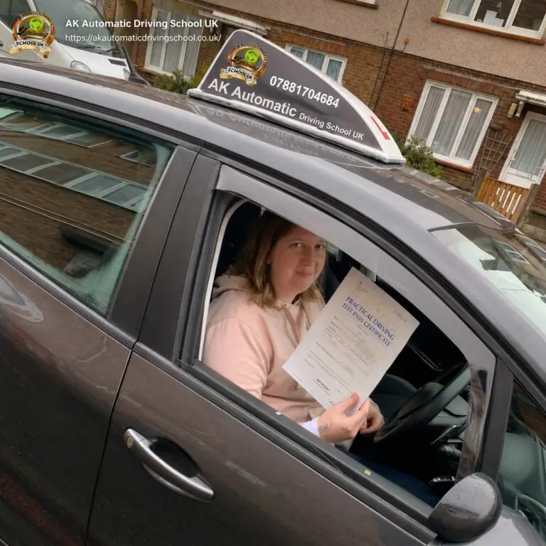 AK Automatic Driving School pupil holding a pass certificate from the car window