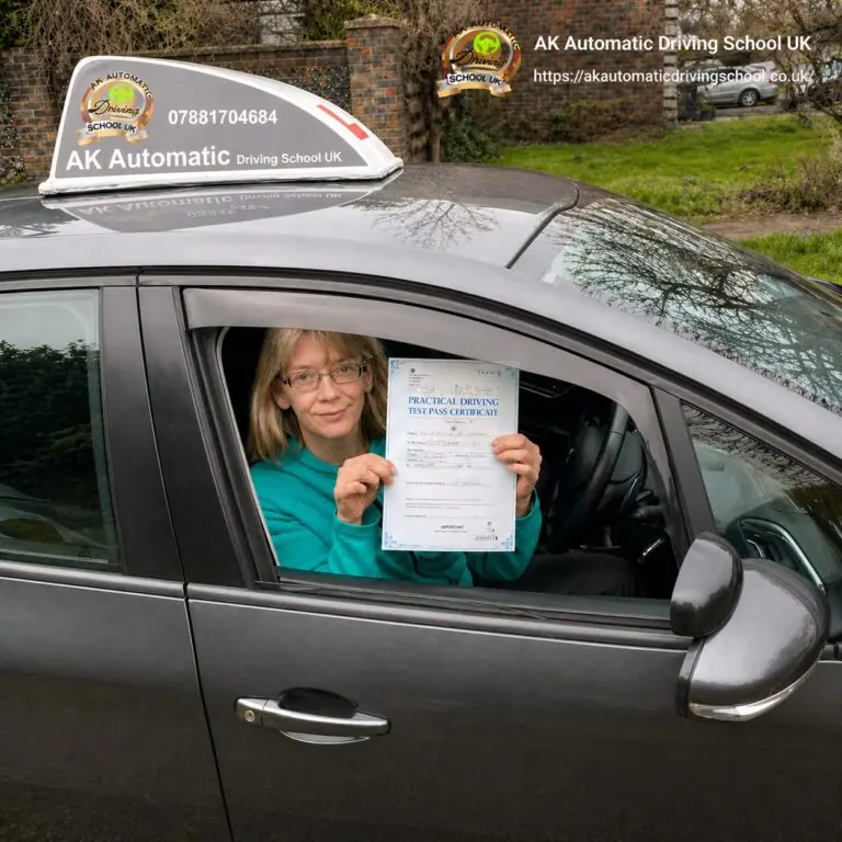 AK Automatic Driving School pupil holding a practical test pass certificate from the car window