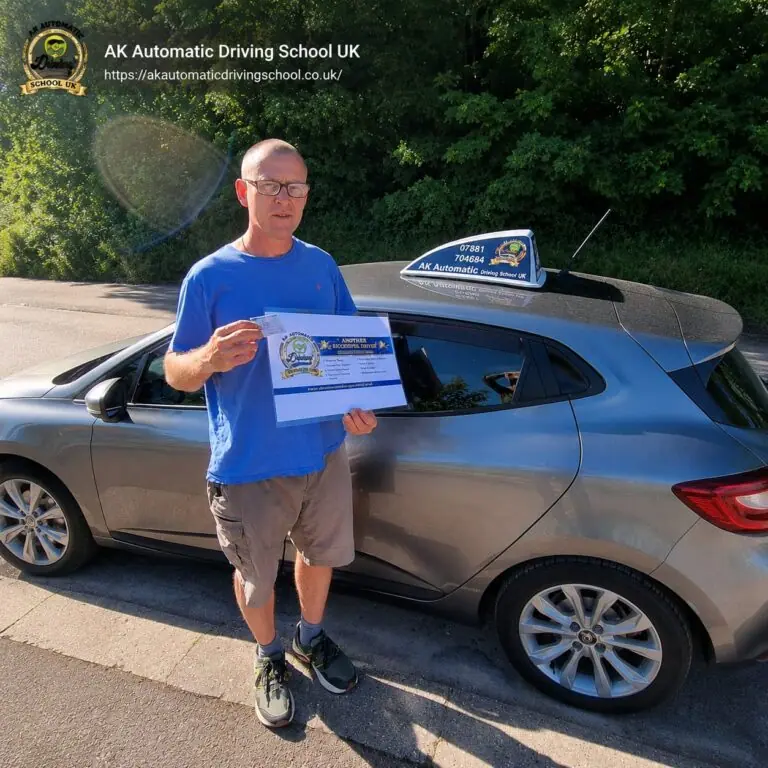 AK Automatic Driving School pupil holding a pass certificate beside the instructor car